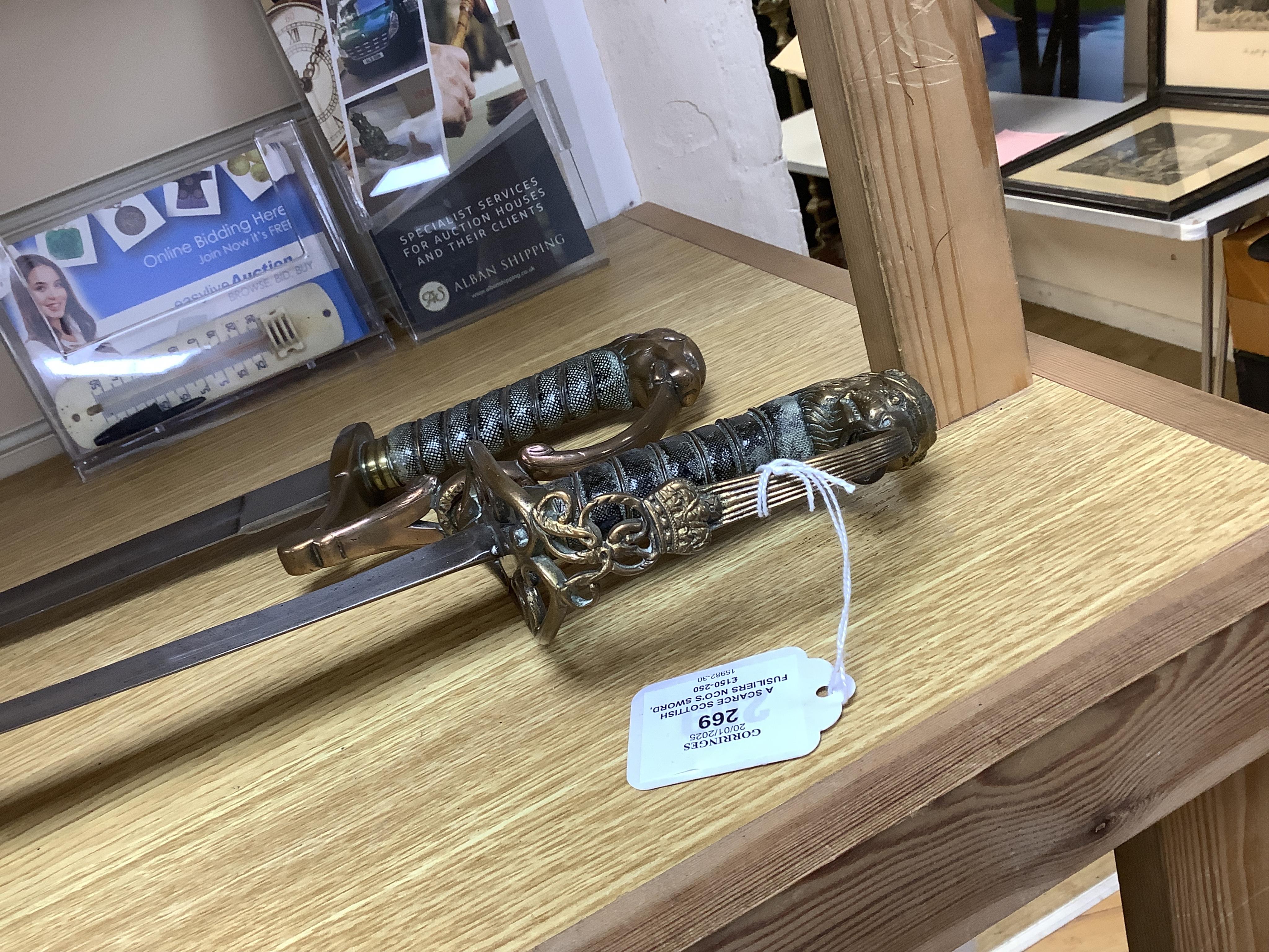 A scarce Scottish Fusiliers NCO‘s sword, with regulation stirrup hilt, regimental badge, lion’s head pommel, wire bound grip, plain blade, together with an 1803 infantry officer’s sword with regulation brass hilt, wire b